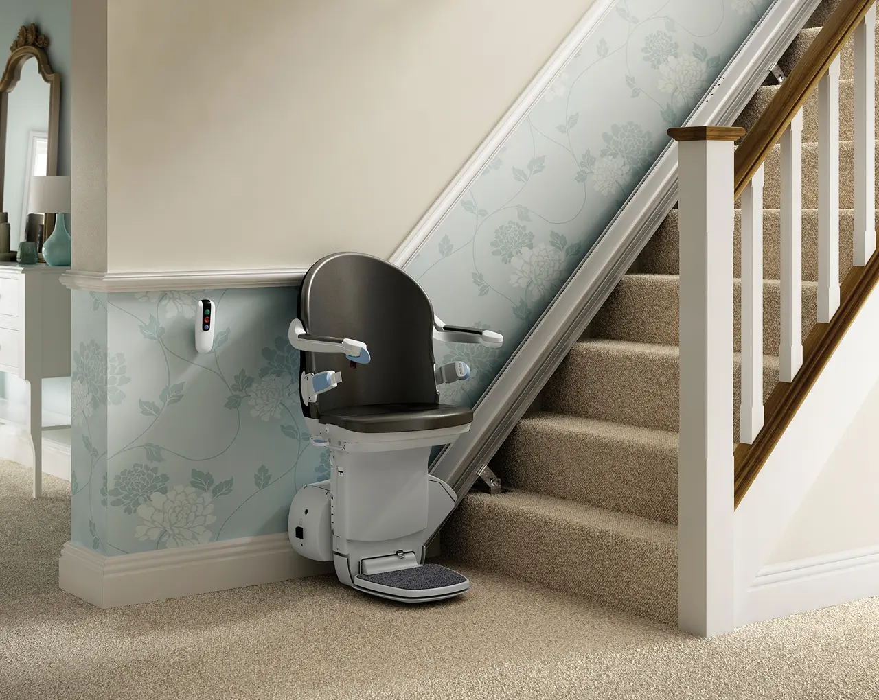 A stairlift with black seat at the bottom of the stairs.