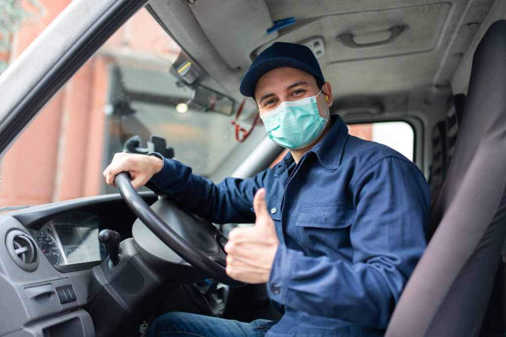 Masked Engineer, gives the thumbs up from the front seat of his truck