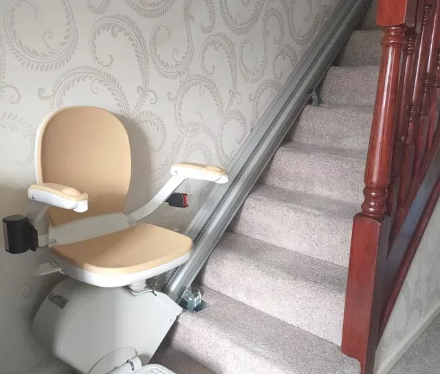 A stairlift at the bottom of the stairs.