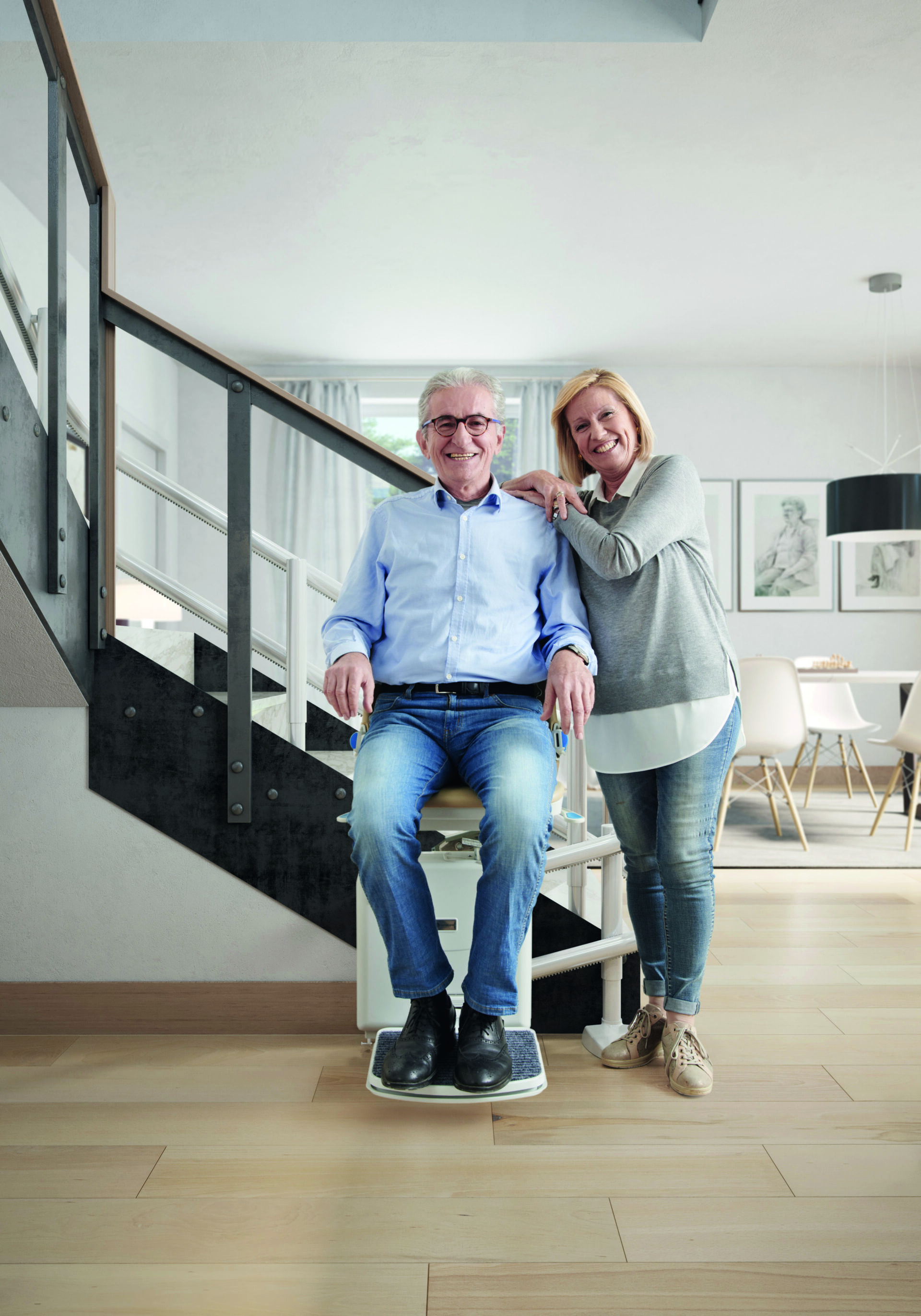 Handicare 2000 - A happy couple in a modern open home utilise a Handicare 2000 stairlift to regain mobility and freedom.