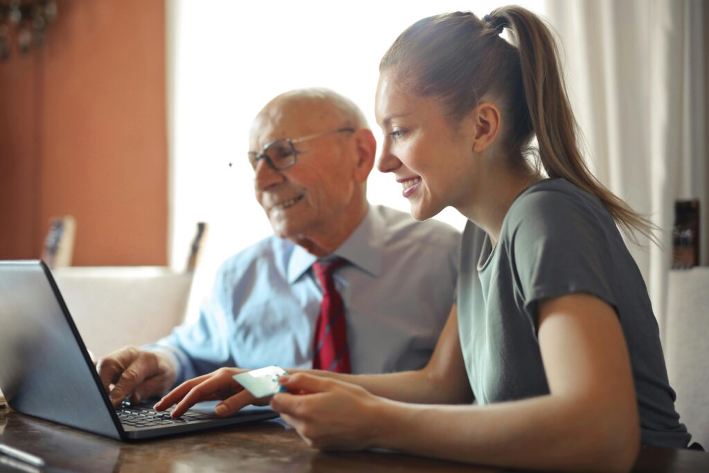 Senior man Looking at the cost of a Stair lift with young soman