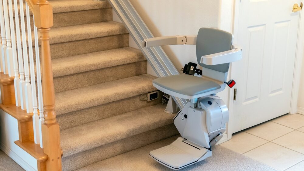 An electric motorized straight chair lift for persons with disabilities.