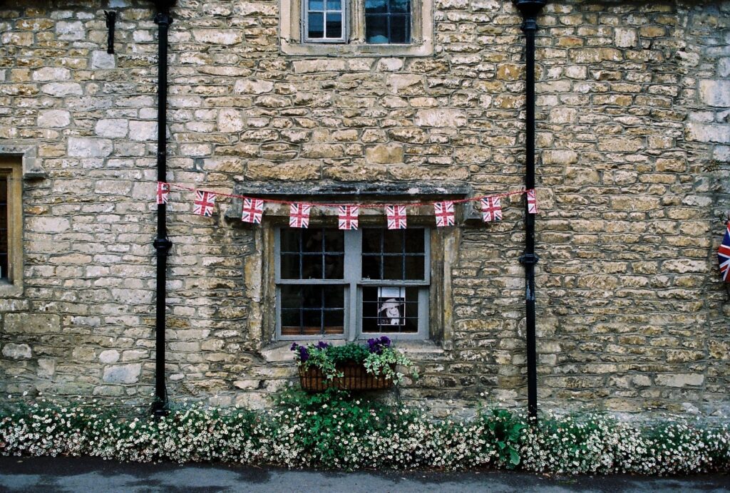 old UK brick home with Union Jack flag bunting