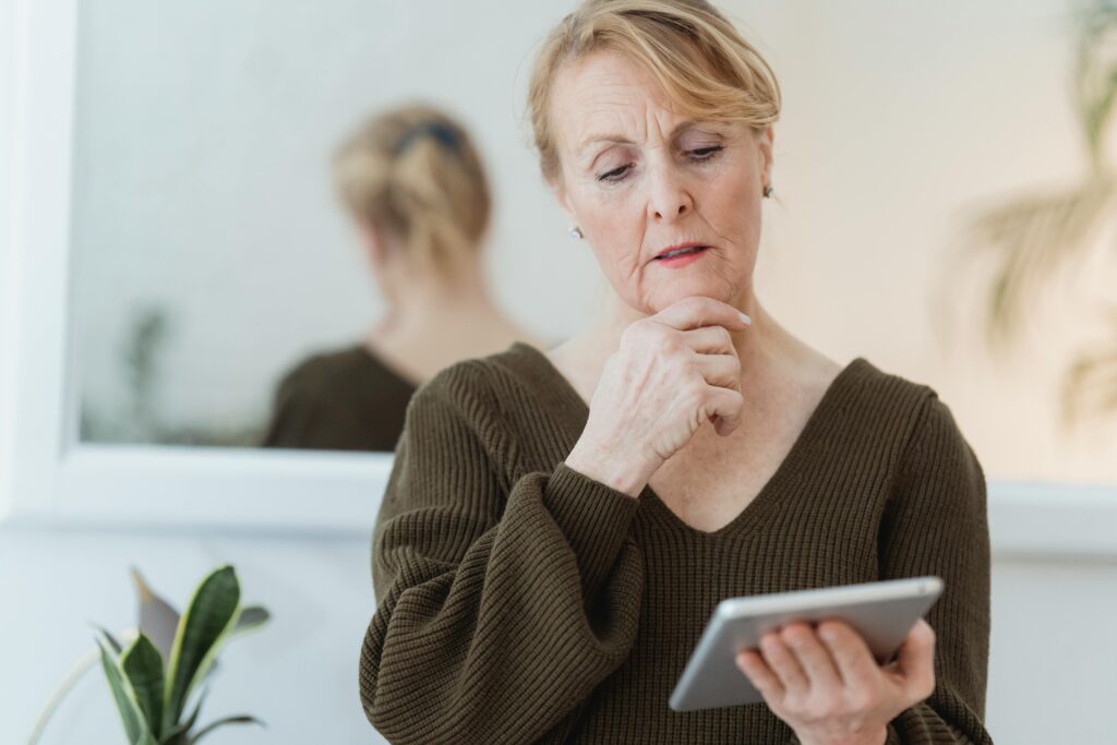 Senior Woman look at a tablet and considering stair lift will be ideal for her physical ability