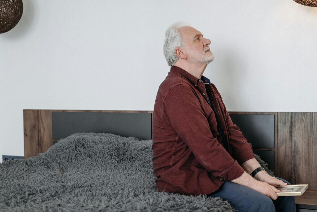 Senior man relaxing on his bed